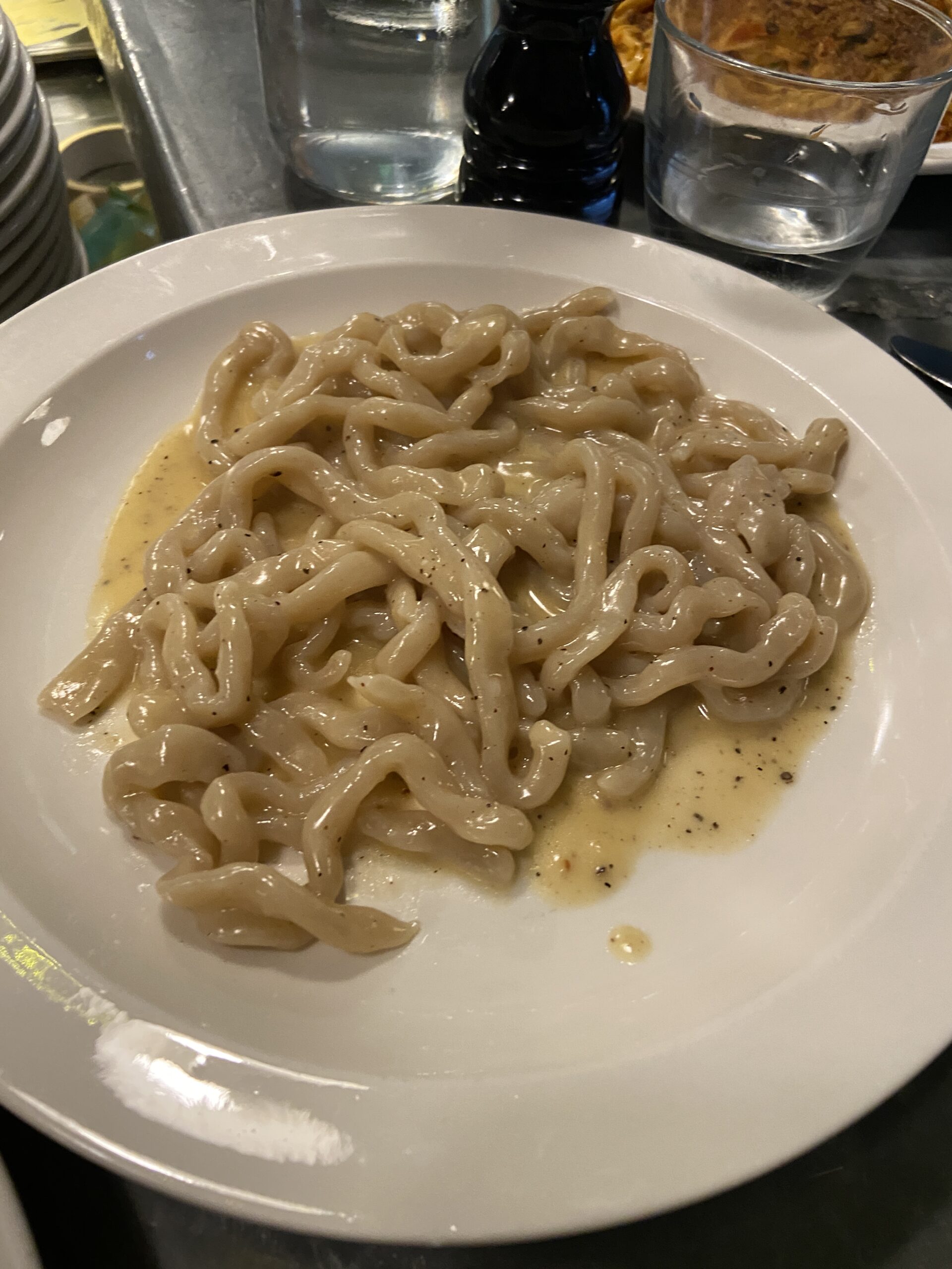 Thick hand-rolled noodles in a creamy sauce speckled with black pepper.