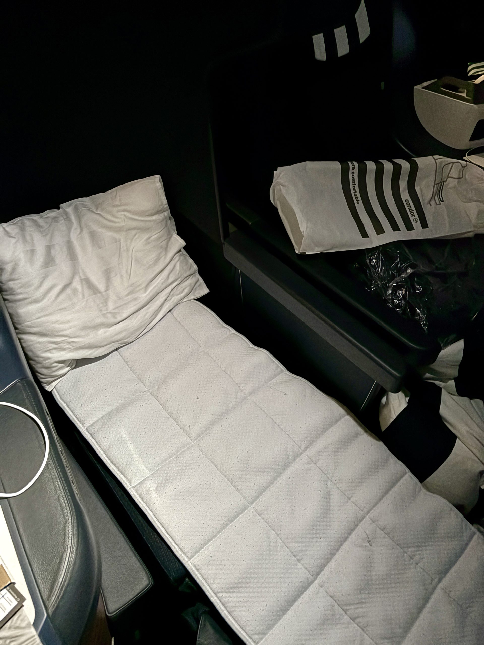 Fully made bed with mattress liner and pillow
