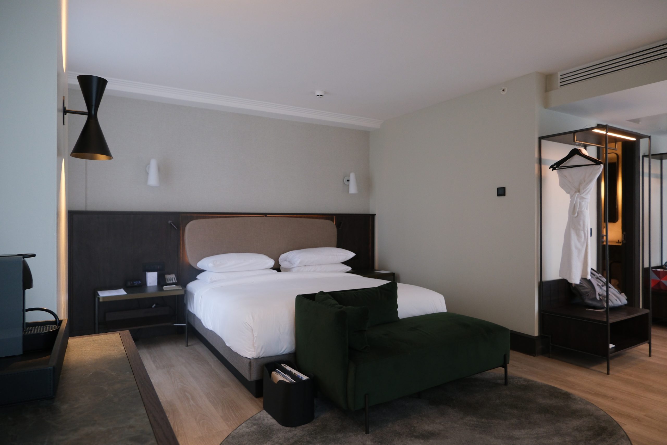 Open bedroom design with large king bed and sectional couch