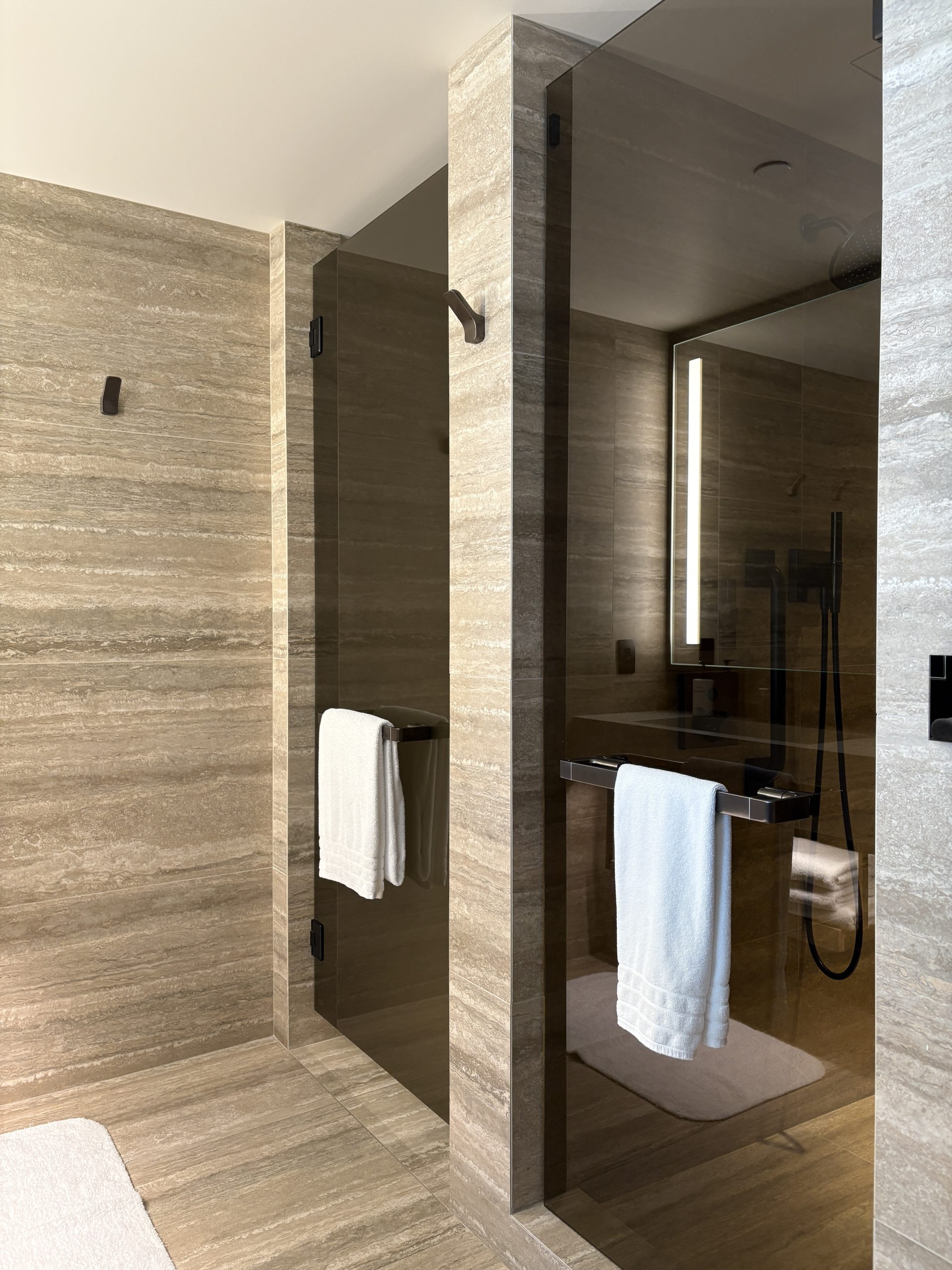 Frosted glass doors leading to the toilet and walk in shower