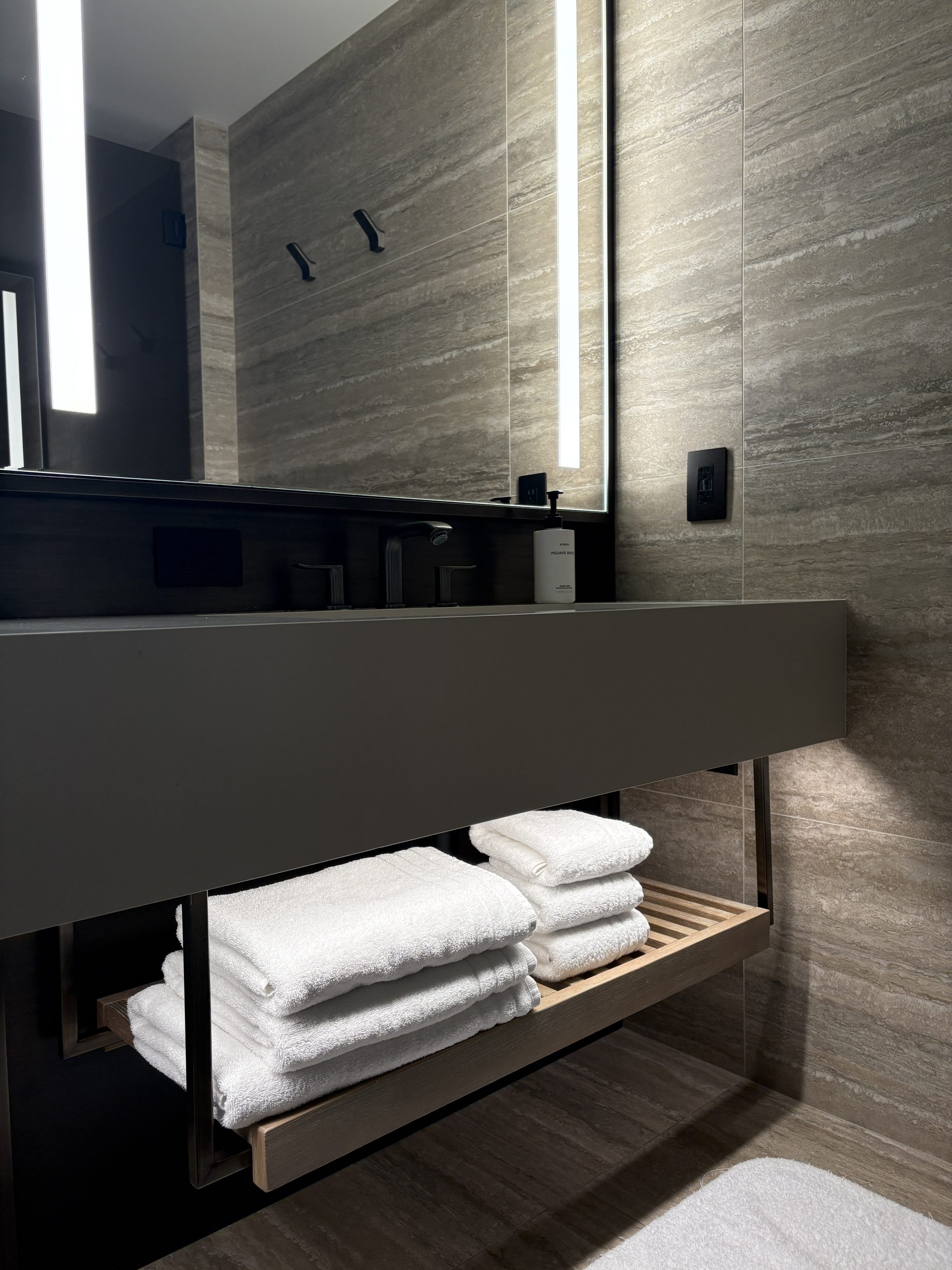 Wide bathroom vanity with towel rack underneath the sink