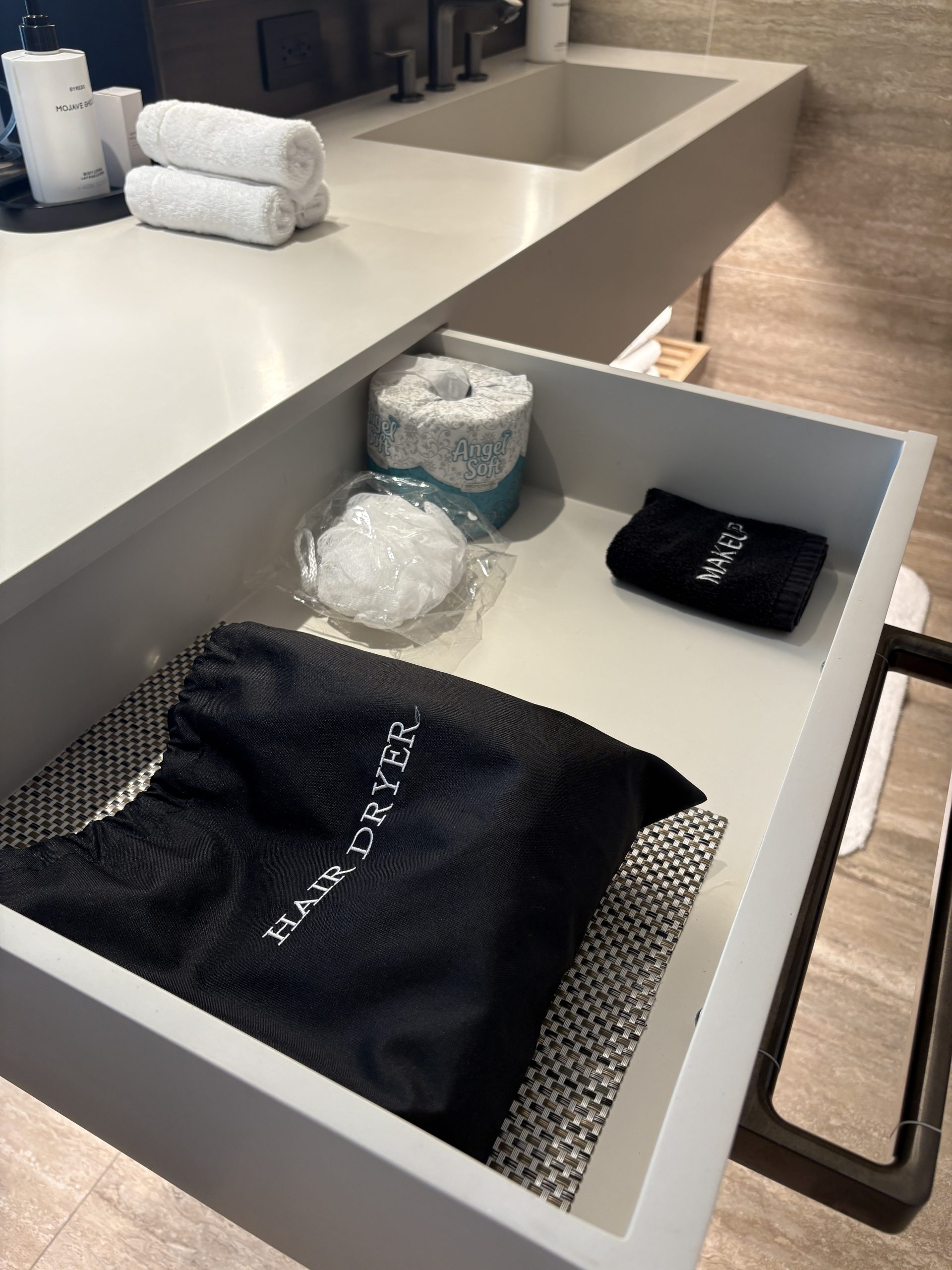 Vanity drawer stores the hair dryer and other bath amenities