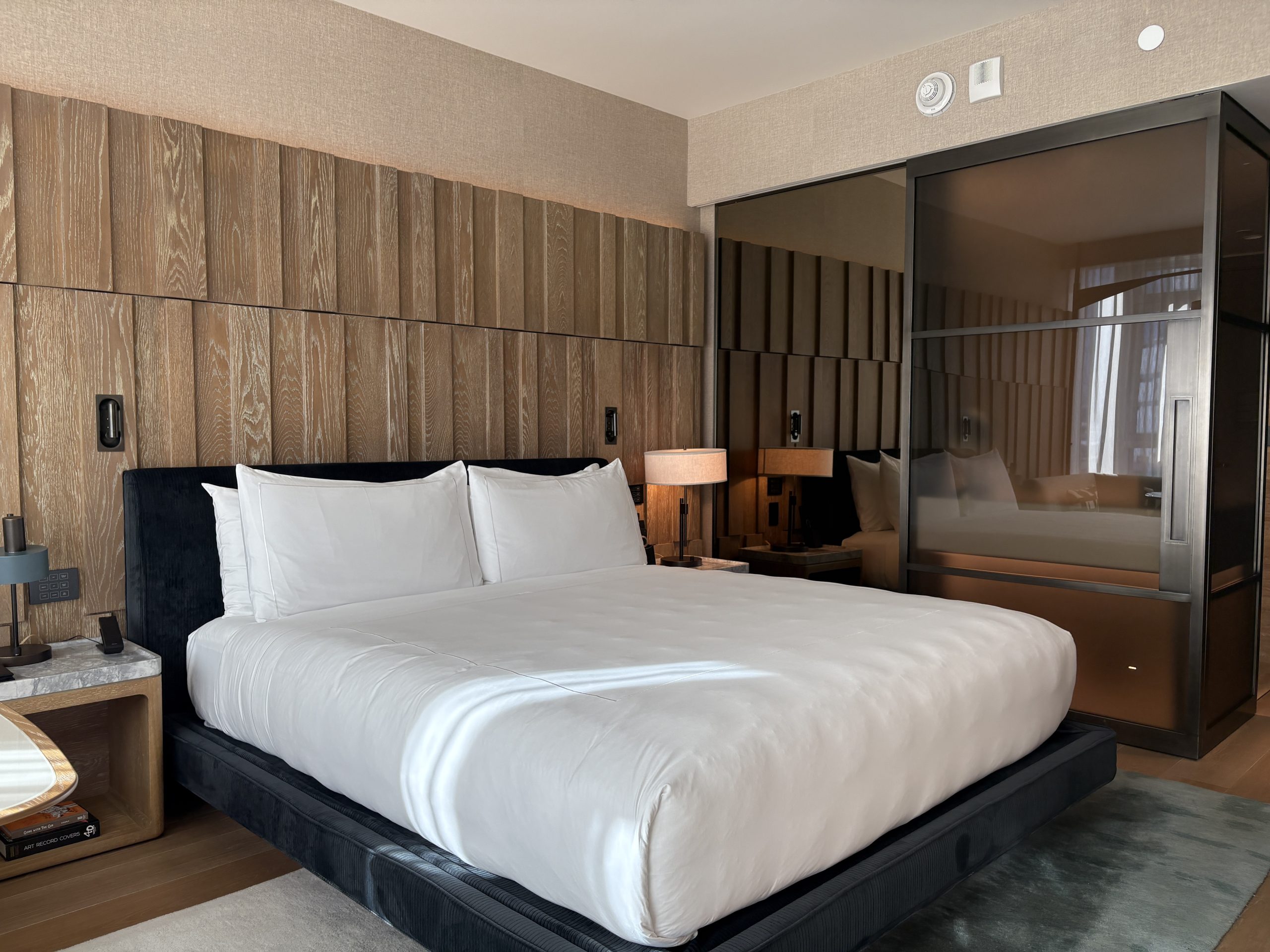Large king bed with a nice wooden accent backboard