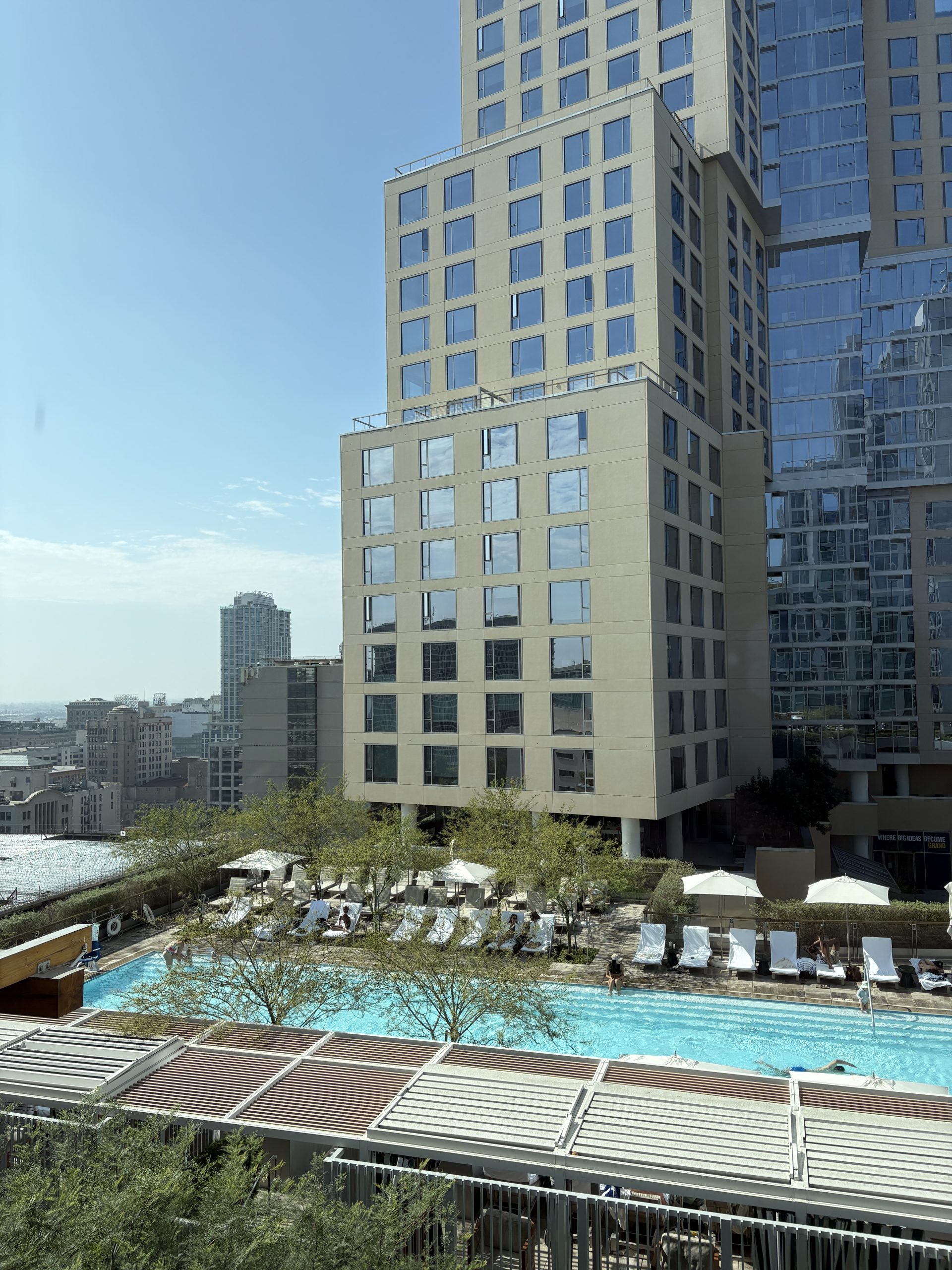 View of the large roof top swimming pool from the bedroom