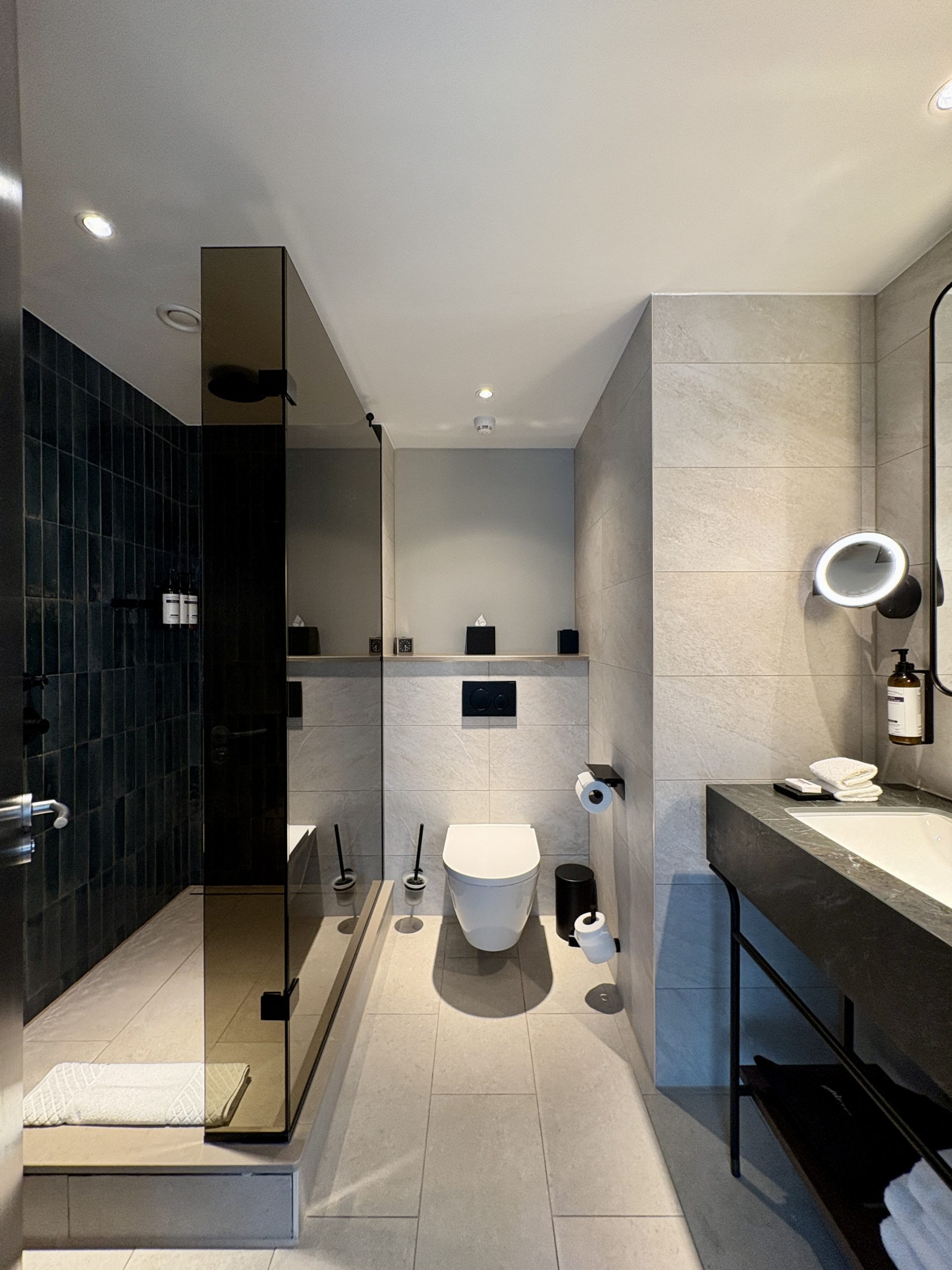Functional bathroom with walk in shower, however, a bit small for a suite bathroom