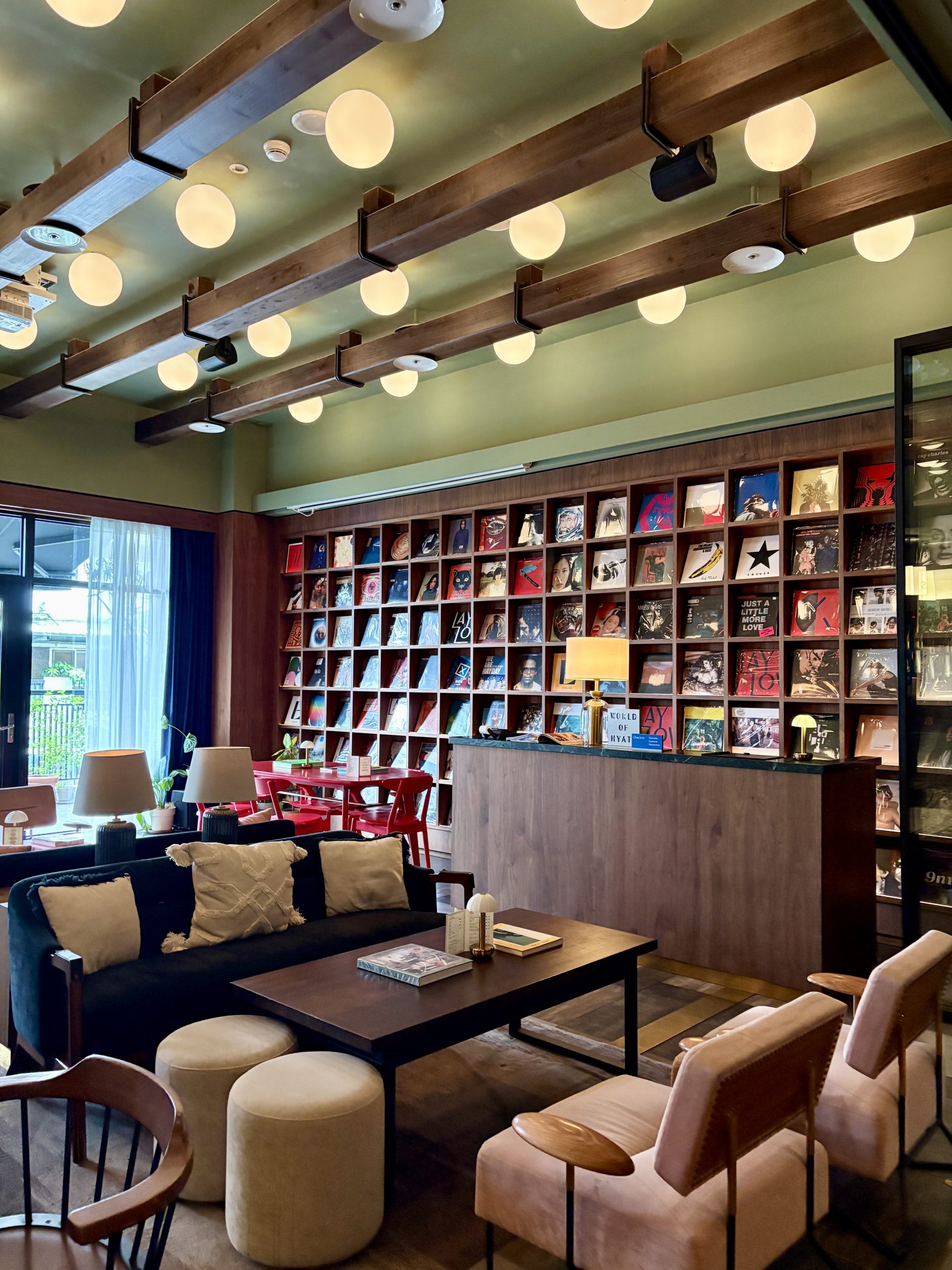 Musically themed lobby with a wall of vinyl records and cozy chairs