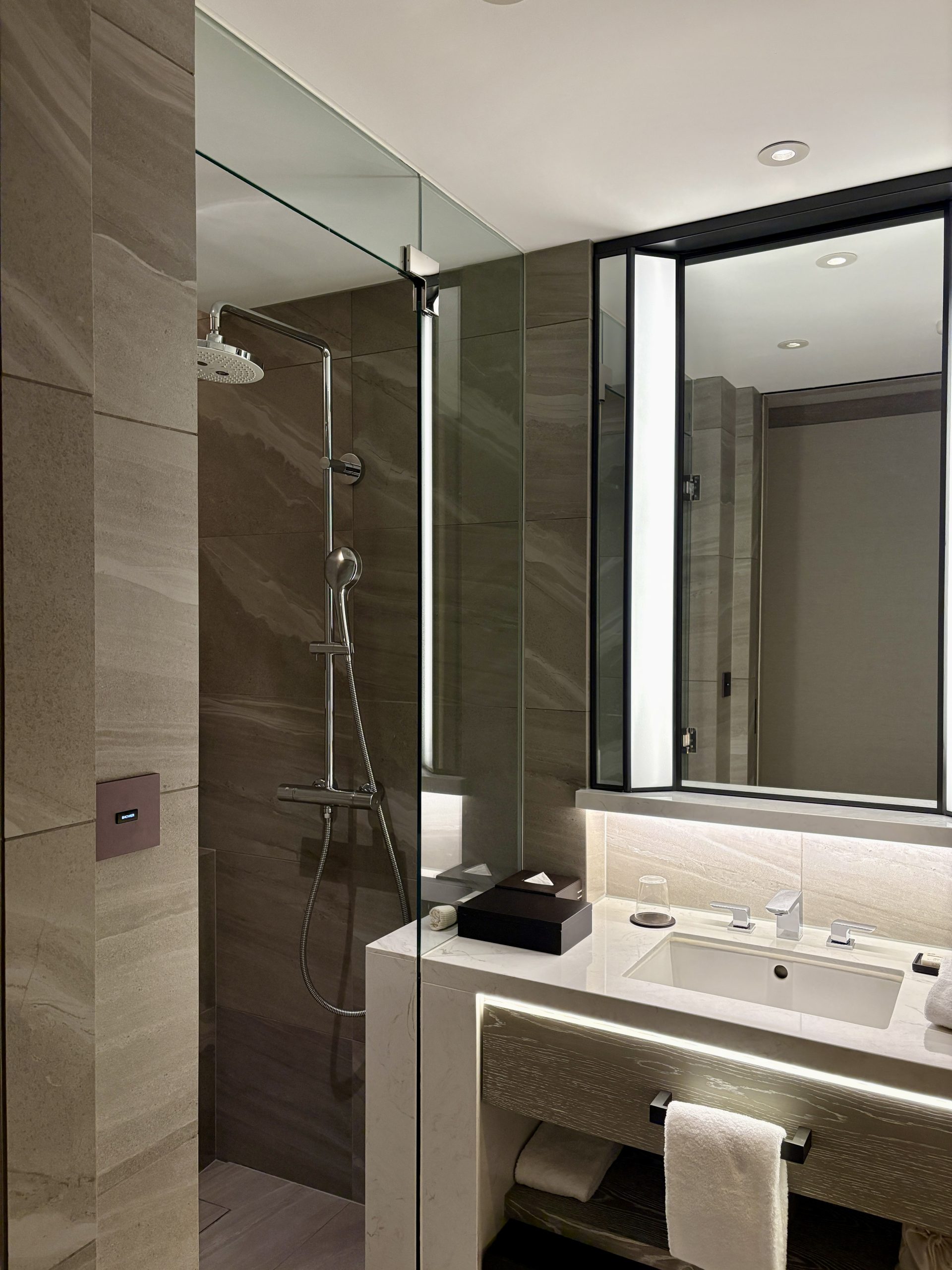 Walk in shower with premium bath amenities at the entrance bathroom