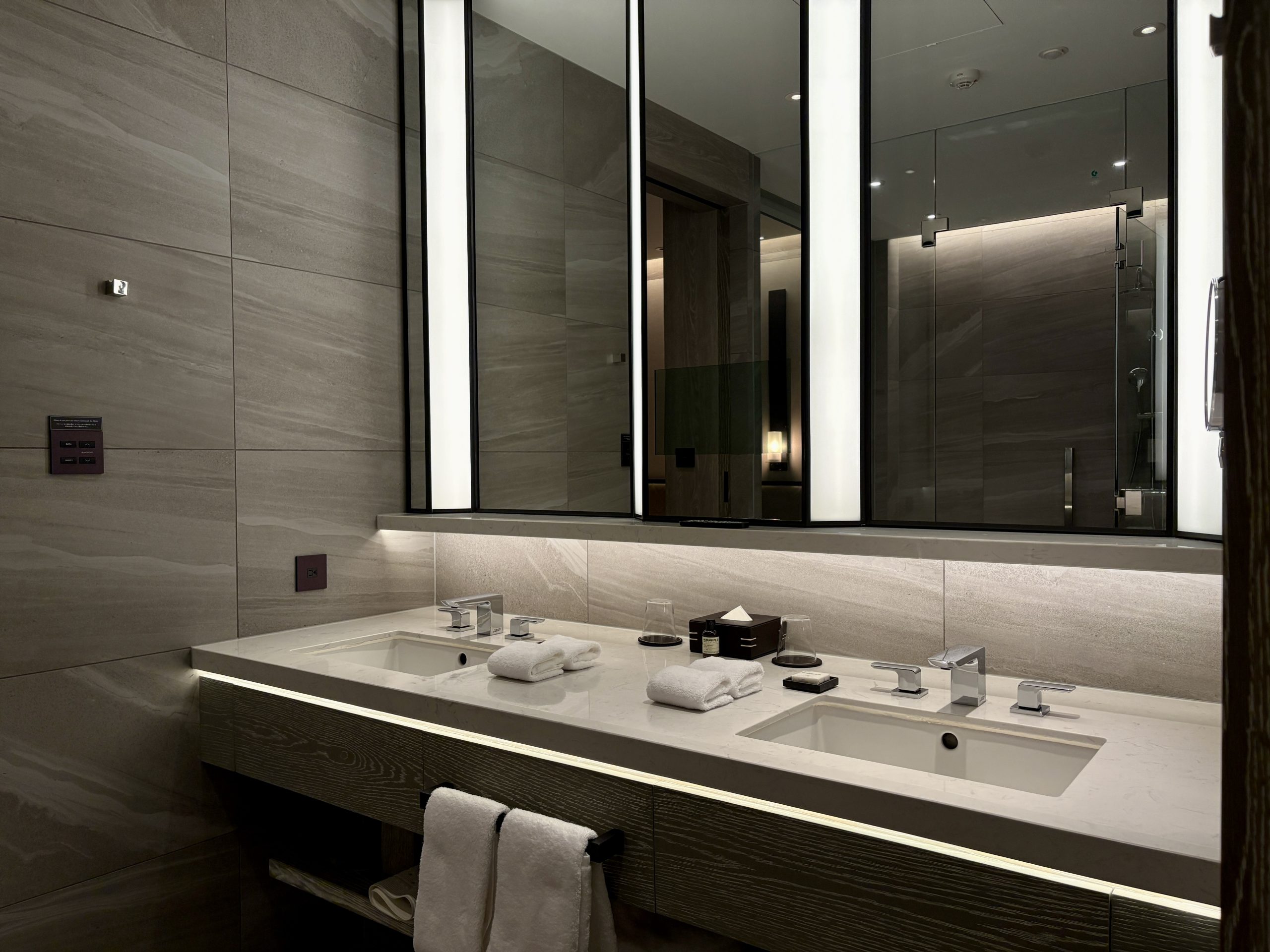 Double vanity with bath products, mirrors, and outlets in the on suite bathroom