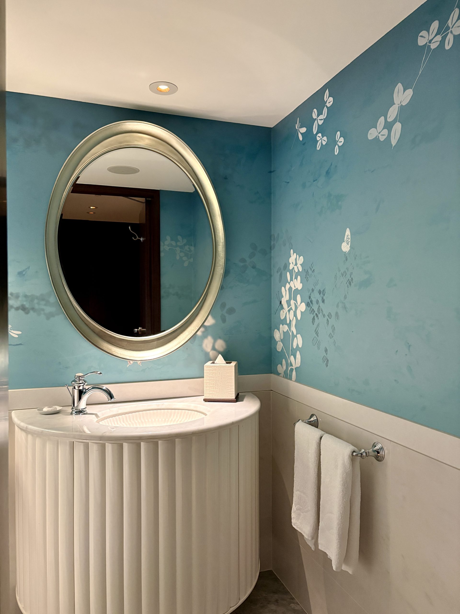 Bright washroom design offers a refreshing contrast against the main room