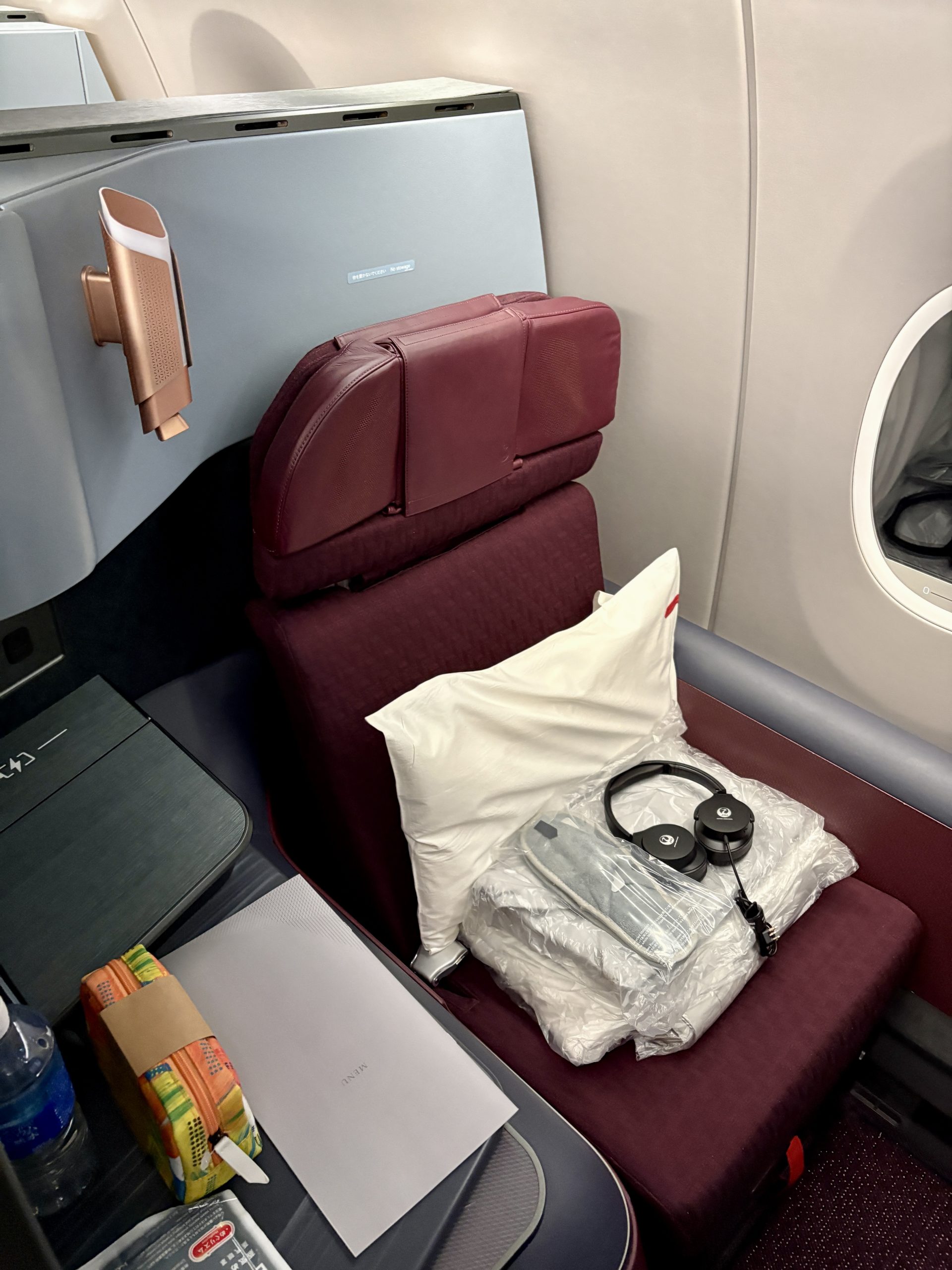 The seat came with pillow, blanket, pajamas, slippers, and headphones.