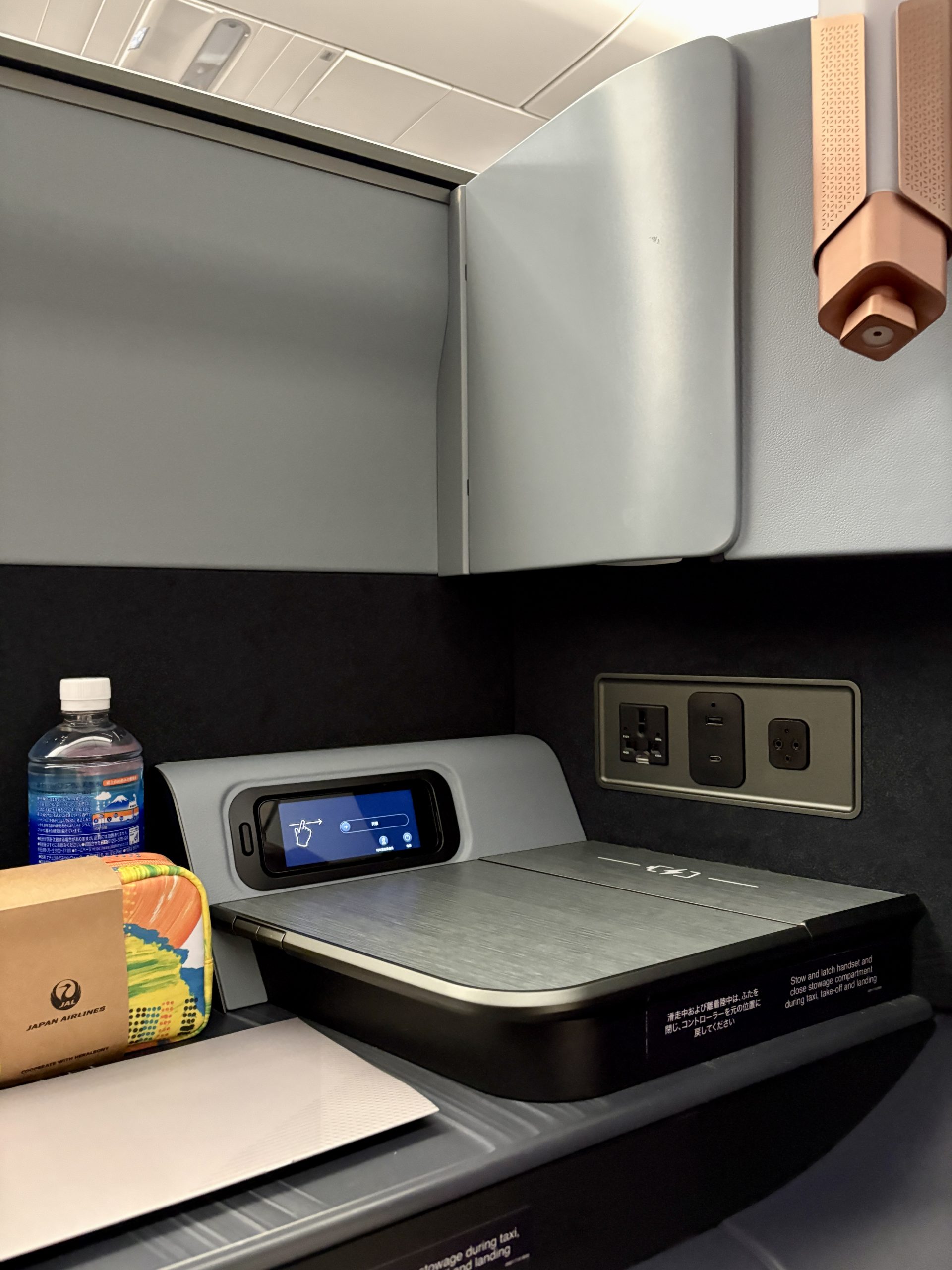 Lantern-designed reading lamp and charging area next to the seat