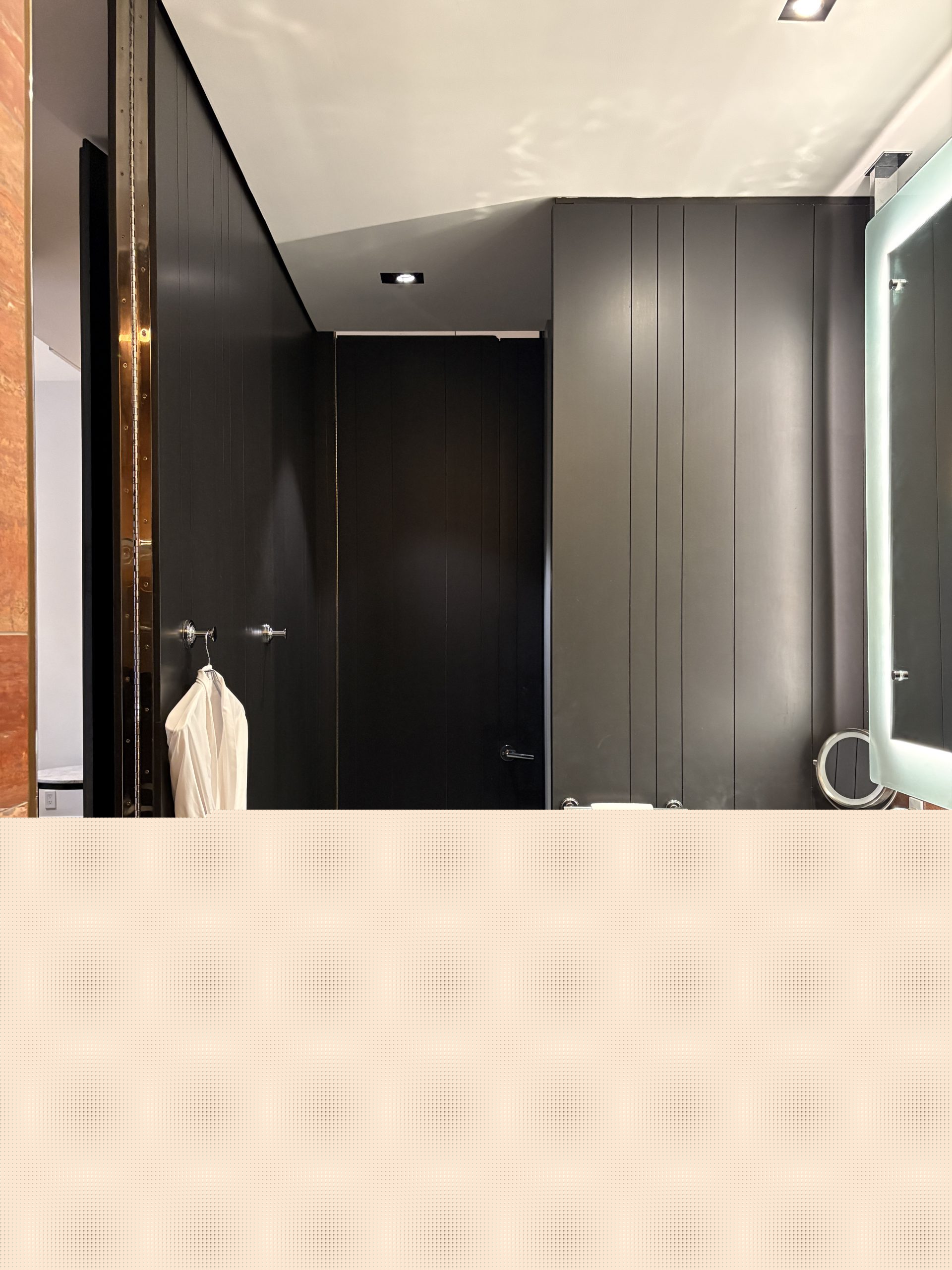 Wall separation in the bathroom for the toilet and the door leading to the front entrance