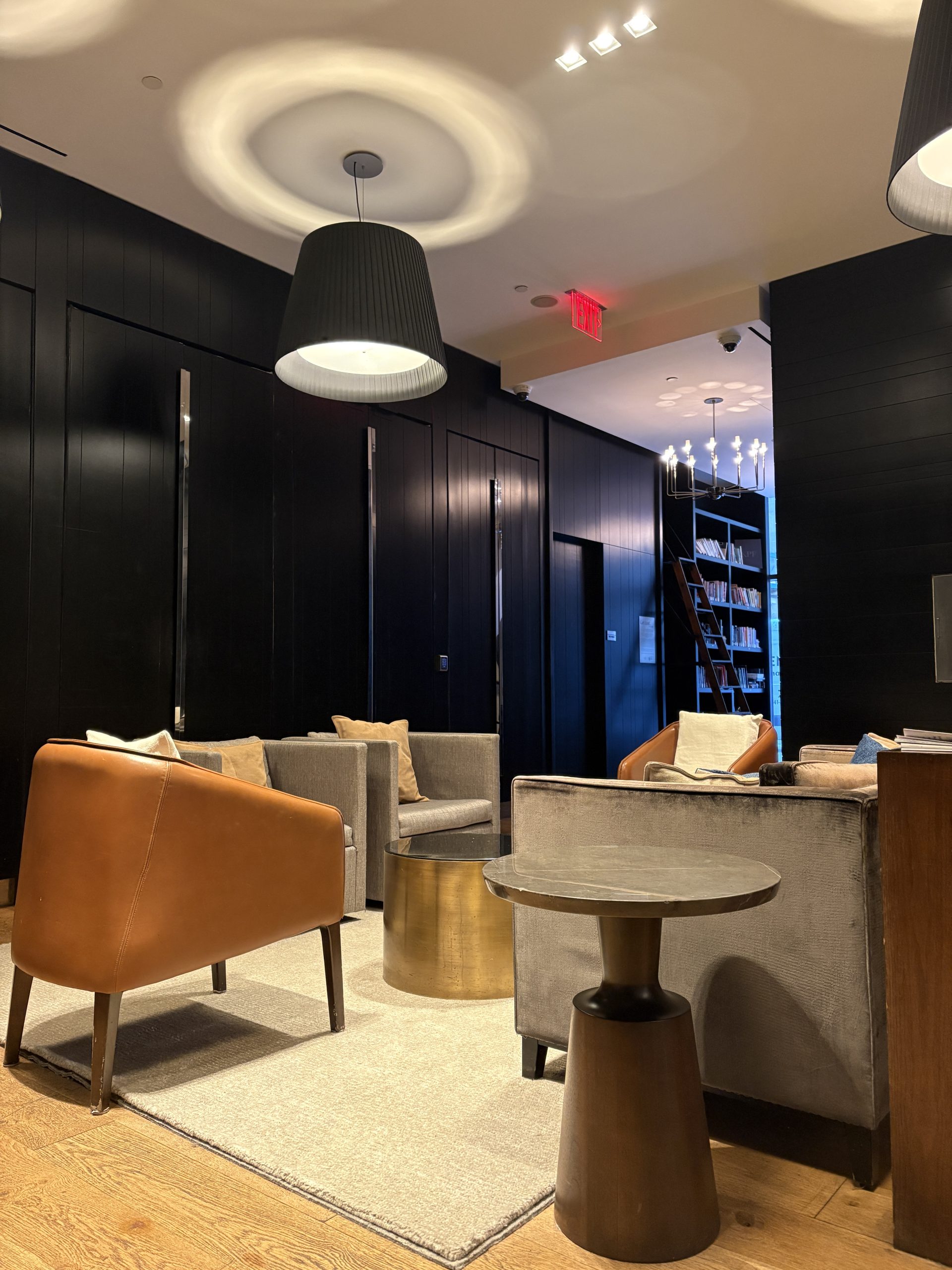 Andaz 5th Ave lobby lounge area with a library nook