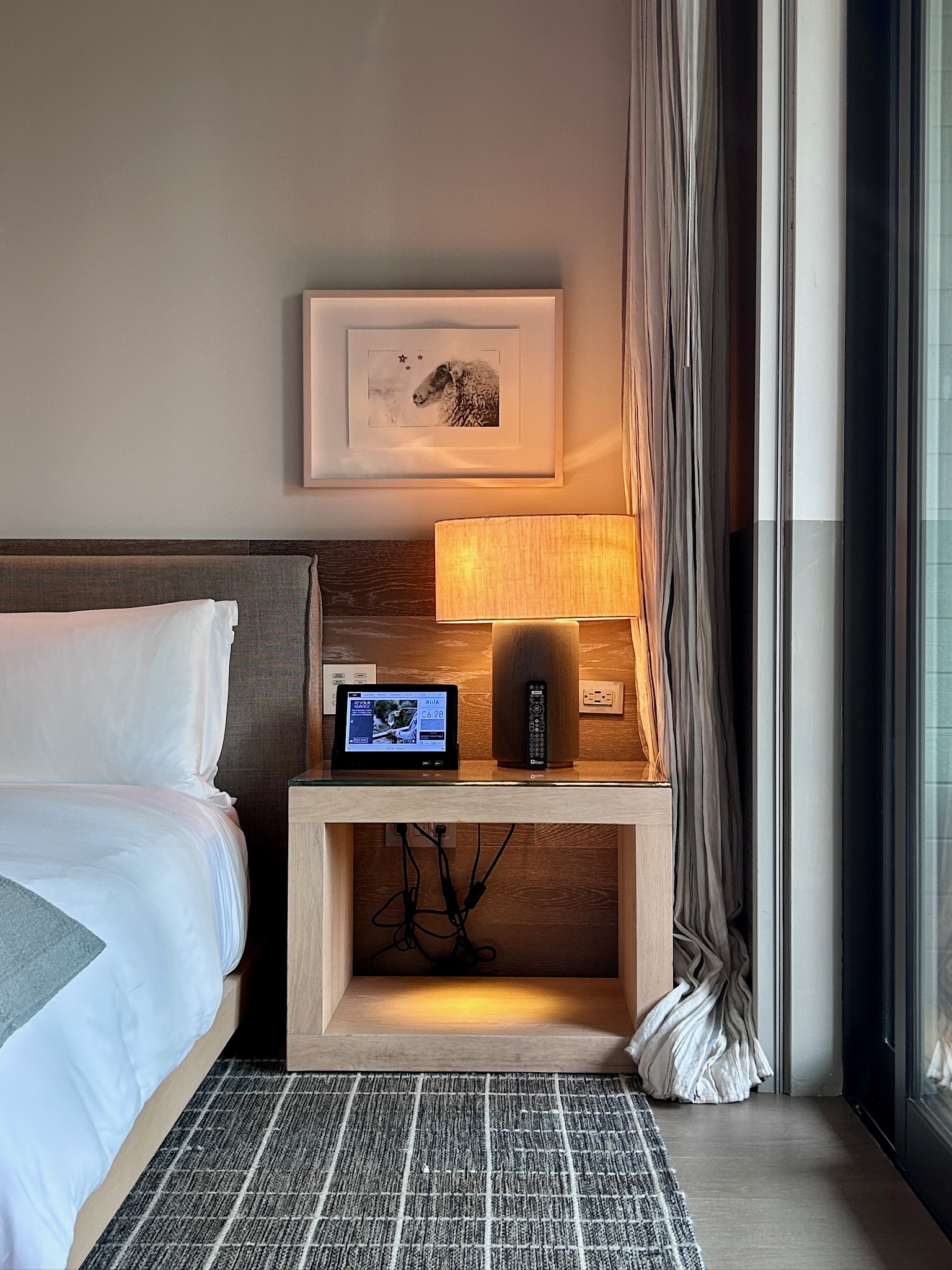 Smart control panel and an in-room entertainment system by the bed-side table