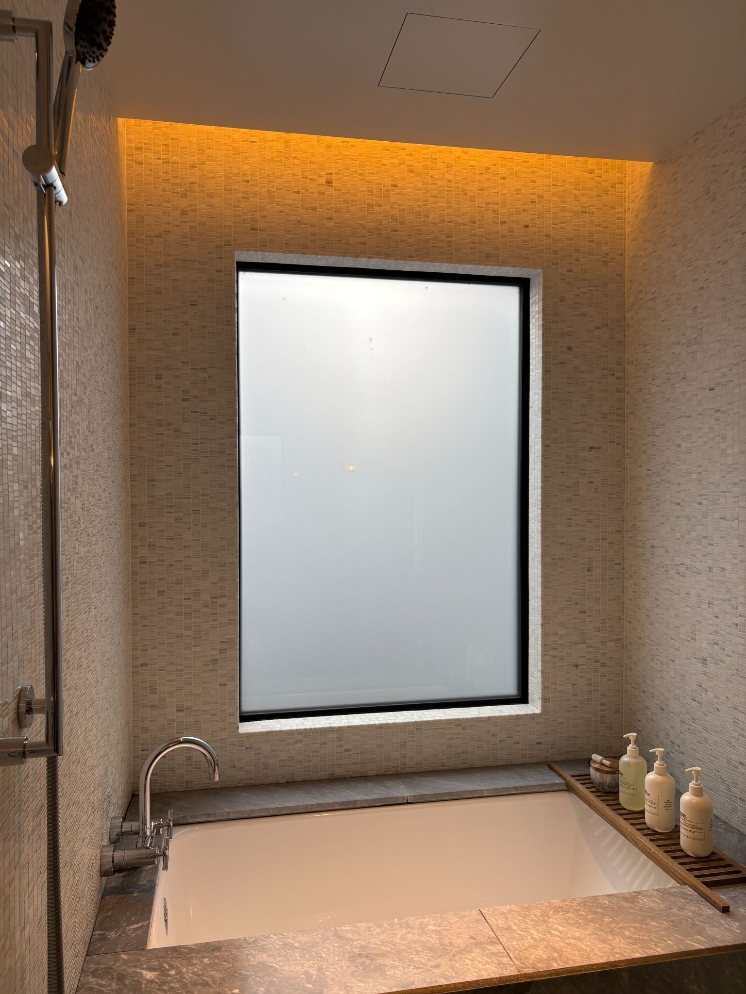 Soaking tub next to the frosted window
