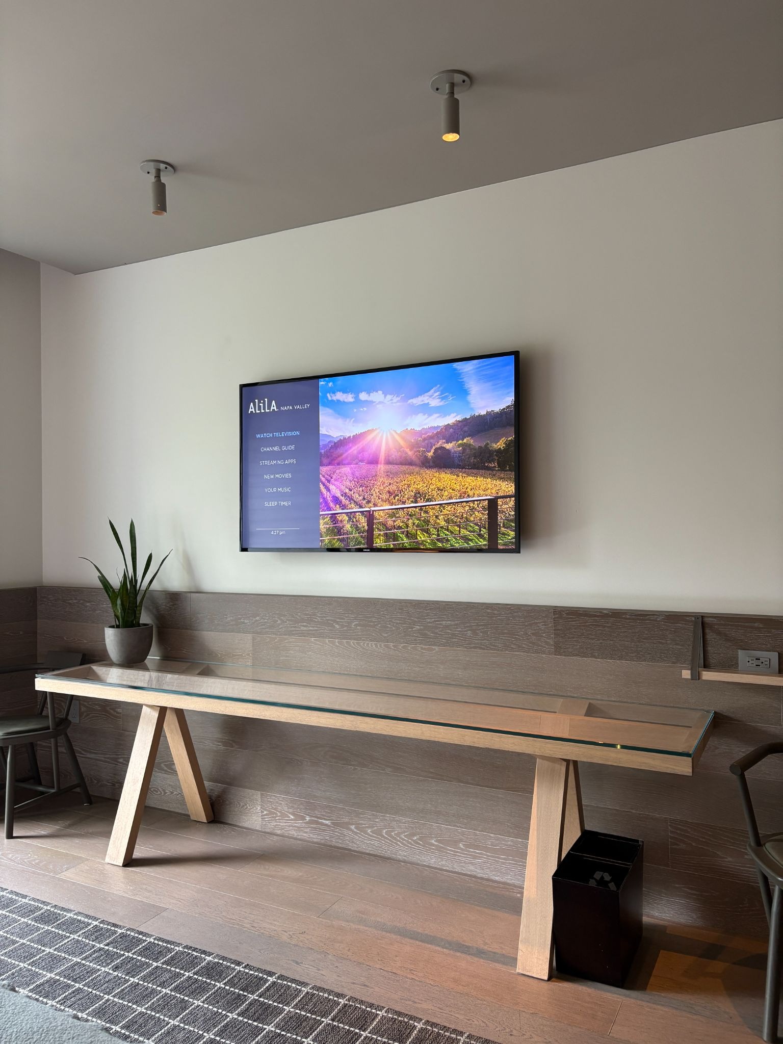 Long glass TV console table that serves as a work station