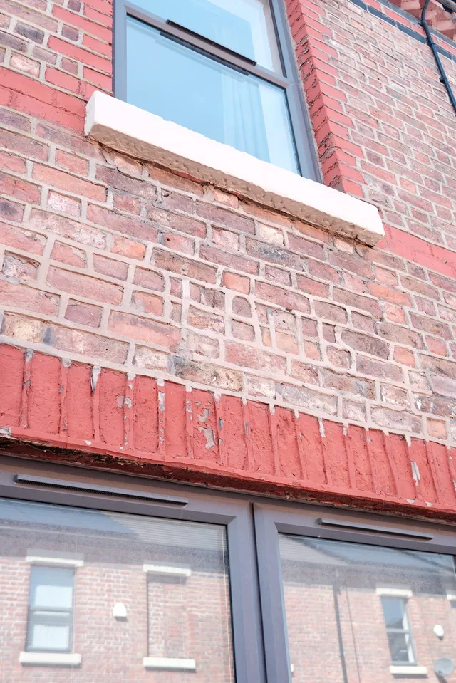 mortar that spelled out BEATLES on the brick wall