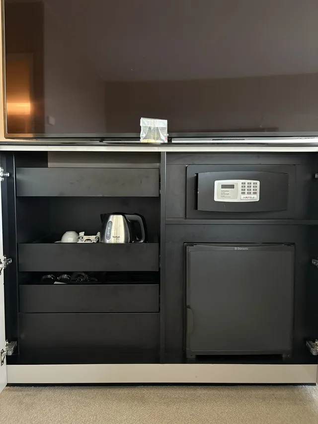 Coffee & Tea station, safe, and mini fridge just below the TV