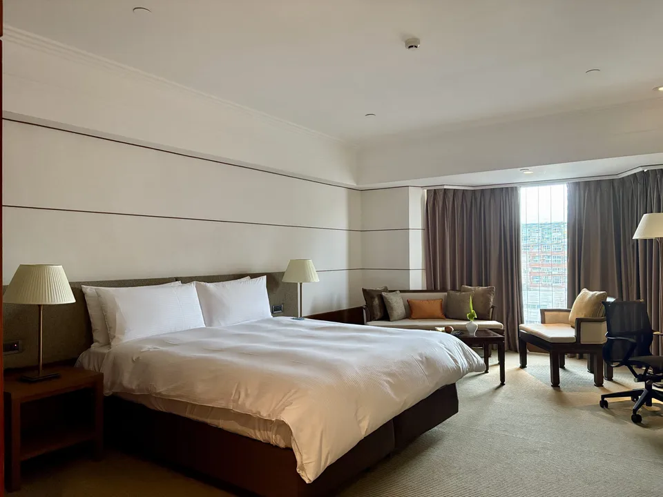 Spacious bedroom with king bed and lounging area