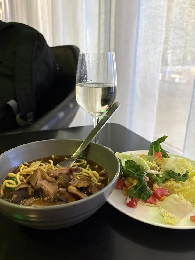 Soup noodles, salad, and wine at the One World lounge