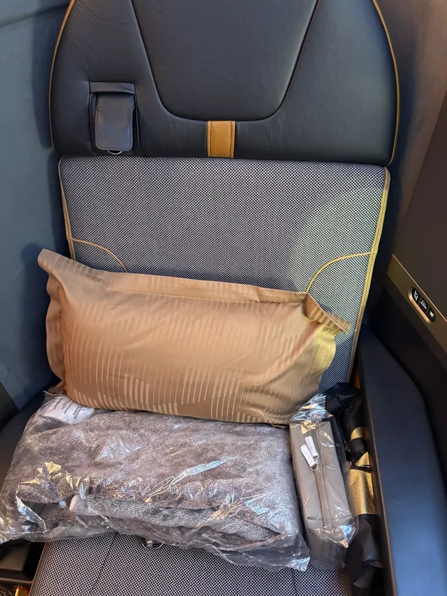 Seat came with pillow, blanket, slipper, and amenities kit