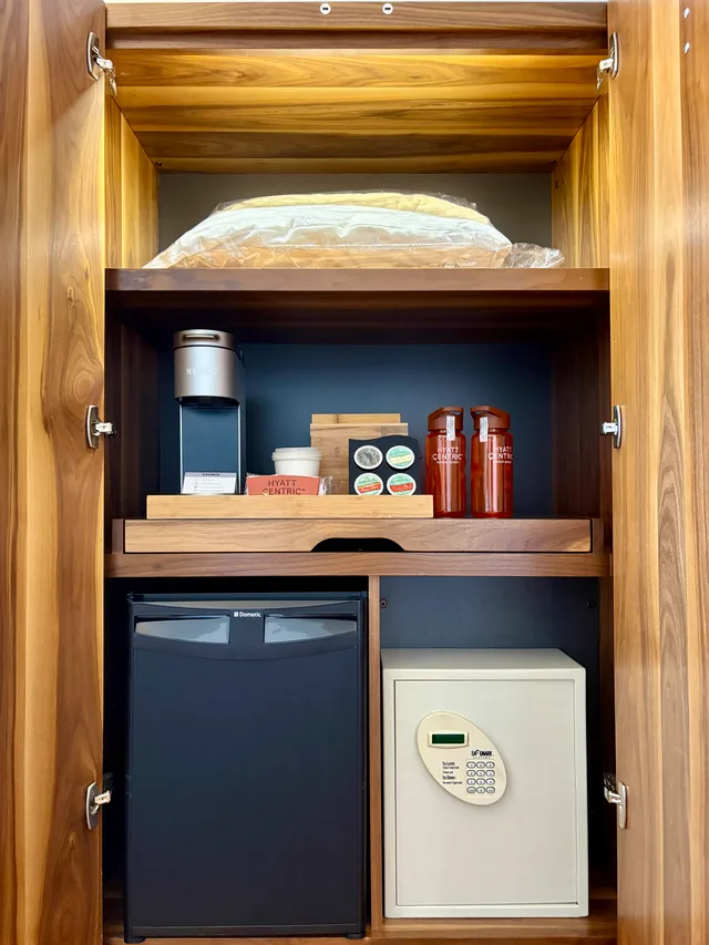 Inside the closet: coffee station, safe, and fridge